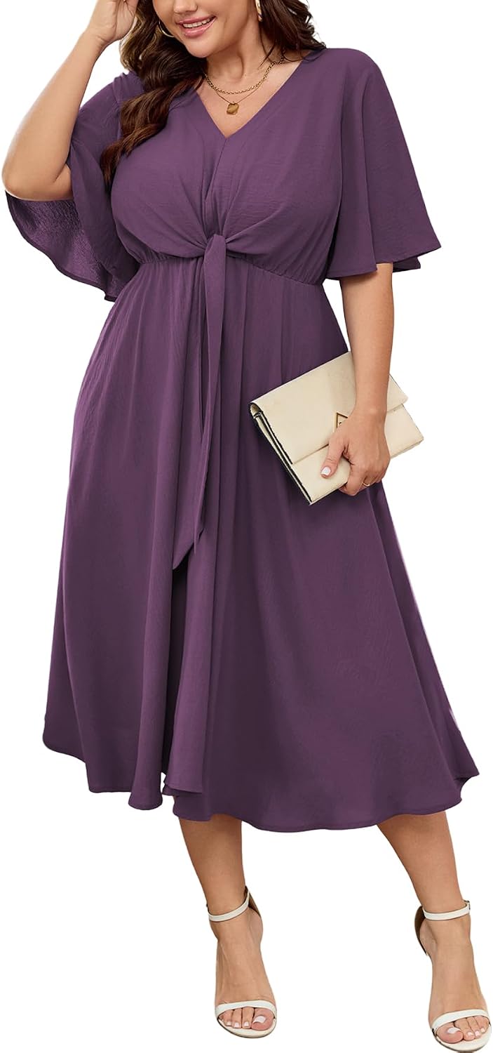 Model posing in flowy midi dress