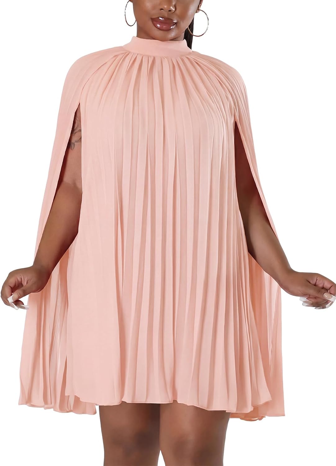 Model posing in cape sleeve mini dress